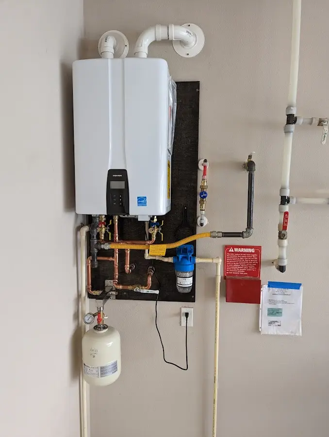 Professional plumber installing copper piping in a Lincoln home